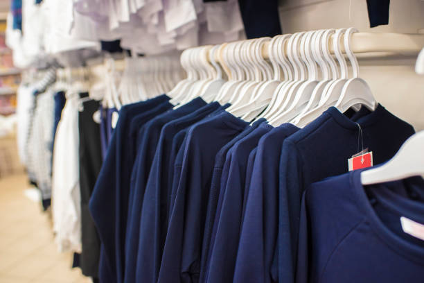 dark blue school uniforms on hangers in a store SCHOOL COLLECTION5 - Image 1