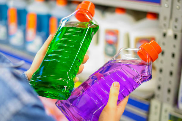 young adult woman choosing bottle of detergent during quarantine with mask DISINFECTANT LIQUID - Image 1